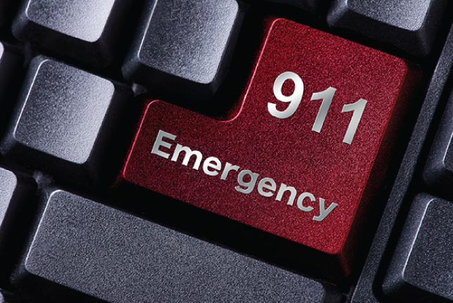 keyboard with large red key that reads 911 emergency